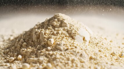 Powdered Substance Cascading in Slow Motion A Study of Texture Movement and Light in a Culinary or Industrial Context Revealing Fine Particles and Dynamic Flow.