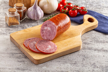 Ham sausage with slice over board