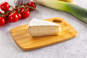 Soft camembert cheese over board
