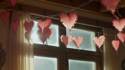 Romantic heart decorations swaying gently in the breeze, casting soft shadows, perfect for Valentine's Day promotions or heartfelt messages - Powered by Adobe