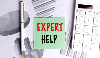 Green card with text expert help on office desk with financial charts, calculator and pen 