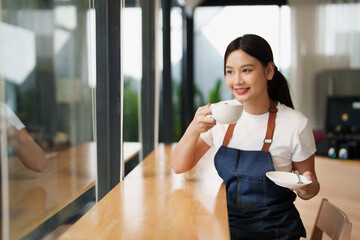 Happy young woman enjoying coffee at cafe counter
