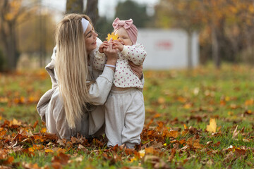 A beautiful woman walks in the park with a child 