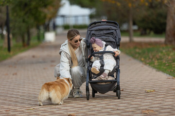 A beautiful woman walks in the park with a child 