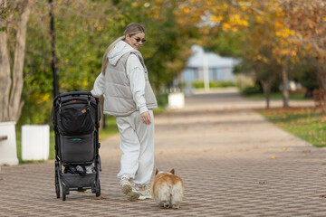 A beautiful woman walks in the park with a child 