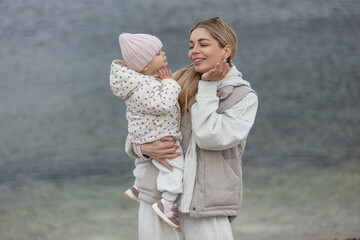A beautiful woman walks in the park with a child 