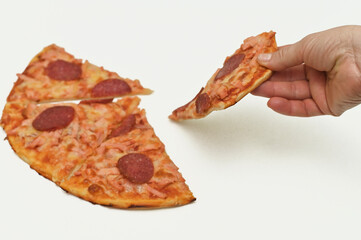Hands pulling apart a slice of pizza with pepperoni, showcasing the cheesy stretch and delicious toppings. The pizza slice is fresh and savory. on a white background.