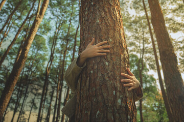 Tree hugging for environmental awareness, hands embracing a large tree in a peaceful forest, symbol of sustainability, nature conservation, eco-friendly lifestyle, climate protection