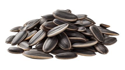 A close up shot of a pile of sunflower seeds with a black background showing the seed textures