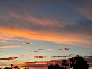 Colorful sunset over southern Spain showcasing vibrant skies and palm trees at dusk