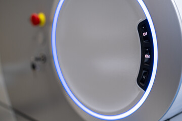 A close-up view of the operational control panel on the main unit of the ZEISS VISUMAX 800 Femtosecond Laser System, featuring the emergency stop, key lock, and a prominent illuminated ho