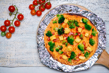Delicious Broccoli and Cheese Pizza with Cherry Tomatoes on Side