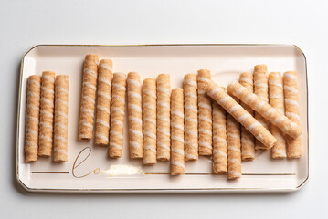 Crunchy Wafer Rolls Neatly Arranged on Decorative Plate