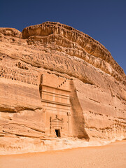 Portal of Nabataean rock cut tombs carved into the mountain face at the Hegra site in Saudi Arabia