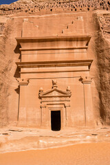 Portal of Nabataean rock cut tombs carved into the mountain face at the Hegra site in Saudi Arabia