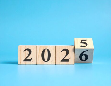 Transition to 2026: Wooden Blocks on Blue Background Showing Year Change - Powered by Adobe