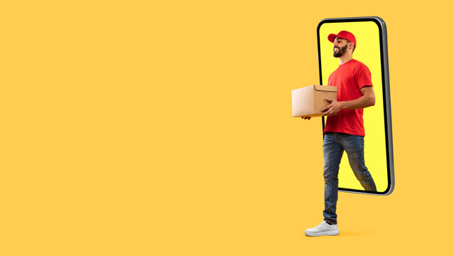 A man in a red shirt and cap is holding a cardboard box as he steps out of a smartphone screen that is displayed on a bright yellow background, representing modern delivery services.