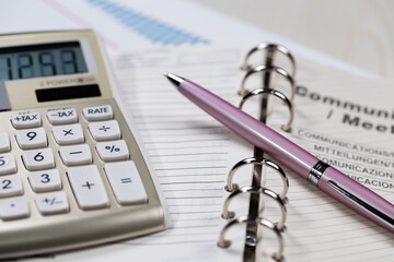 Business and accounting supplies arranged in a composition on an office desk.