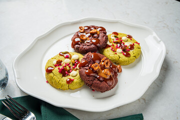 Colorful assortment of freshly baked cookies drizzled with caramel and sprinkled with nuts