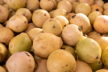 Pile of fresh ripe guavas (Psidium guajava) in a market. Fresh ripe guavas.