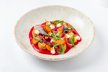 A beautiful presentation of fresh vegetables garnished with herbs and drizzled with sauce