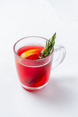 Enjoy a vibrant herbal tea with lemon slices and a sprig of rosemary, ideal for relaxation moments