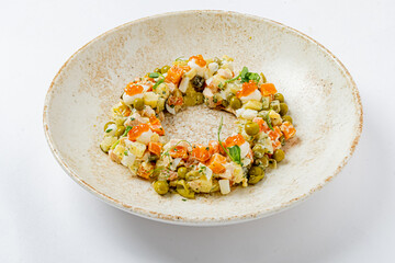 A vibrant salad with mixed veggies, garnishes, and flavorful dressing, served elegantly