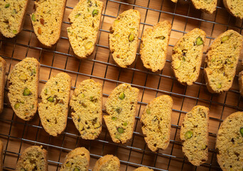Batch of orange and pistachio biscotti - classic holiday flavors - cooling on a wire rack
