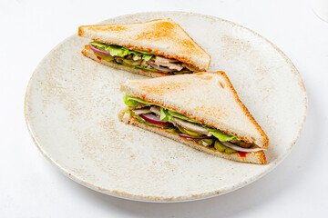 Tasty sandwich with toasted bread, turkey, lettuce, and pickles awaits your lunch!