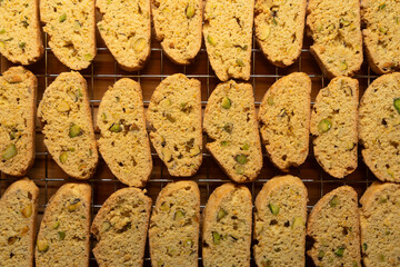 Freshly baked biscotti breakfast cookies with pistachio nuts, cooling on a wire rack