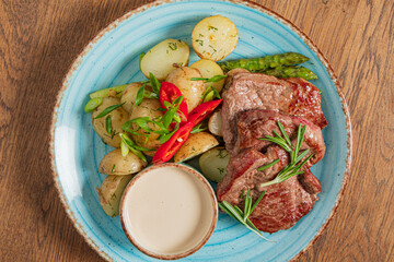 Grilled steak with seasoned potatoes and asparagus makes a delightful meal