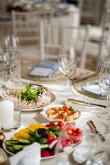 An elegant table setting displays various fresh dishes, showcasing appetizers and vibrant colors