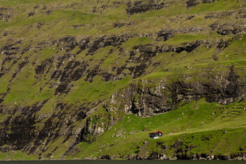A traditional house perched on a mountain near Saksun, Faroe Islands.