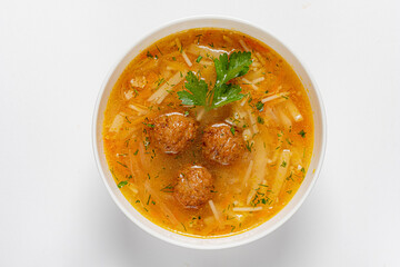 Delicious soup features tender meatballs and noodles, inviting warmth and comfort in every spoonful