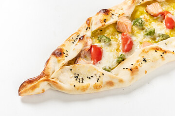 Savor the delightful flavors of lahmacun pide, topped with fresh ingredients, perfect for sharing