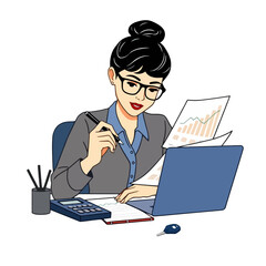 A woman with glasses is working at a desk, reviewing documents and using a laptop, possibly in an office setting.