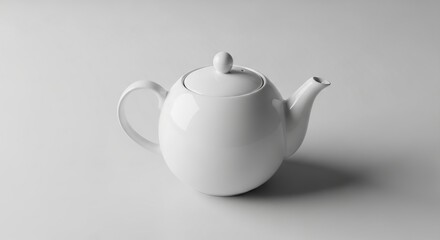 White ceramic teapot with matching lid resting simply on flat clean kitchen surface presentation
