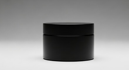 Matte black cosmetic jar with secure matching lid displayed elegantly on clean neutral minimalist backdrop