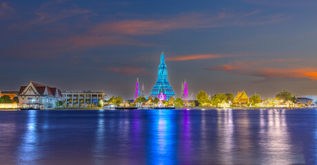 26 November 2025 Beautiful Sunset colours of Thai Temple Wat Arun on Chao Phraya River in BKK Bangkok Thailand. The magic colourful neon light display on the temple at sunset is magical.