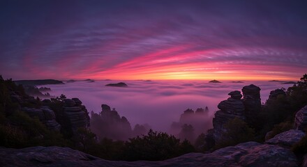 Panoramic view of a vibrant sunrise over a misty mountain range, with unique rock formations