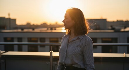 Young caucasian female watching sunset on city rooftop