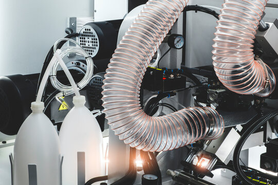 Wood boards on a woodworking machine in a modern furniture factory, woodworking industrial concept background.