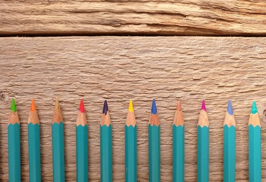 Close up of some colored pencils with sharpened tips on the wooden table. - Powered by Adobe