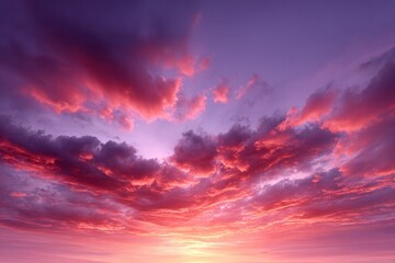 Naklejka premium Crimson Canvas: A stunning display of nature's artistry as fiery red and soft pink hues paint the sky. The ethereal glow of the sun casts a dramatic silhouette.