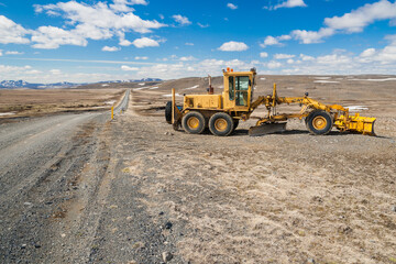 bullzoder next to a mountain road in the lonely icelandic highland