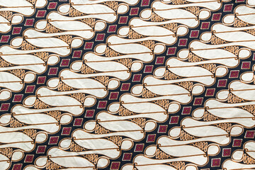 Full frame close-up of a traditional Indonesian Batik fabric featuring the classic "Parang Rusak" or "Parang Barong" texture pattern.