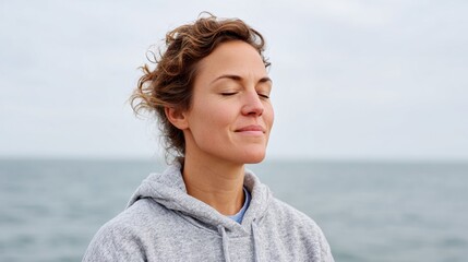 Woman meditating at beach.