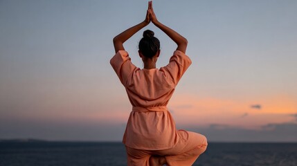 Woman meditating at sunset.