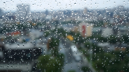 Raindrops on glass, city view creating a calming, introspective mood