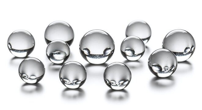 Collection of clear, reflective glass or crystal spheres isolated on white background
